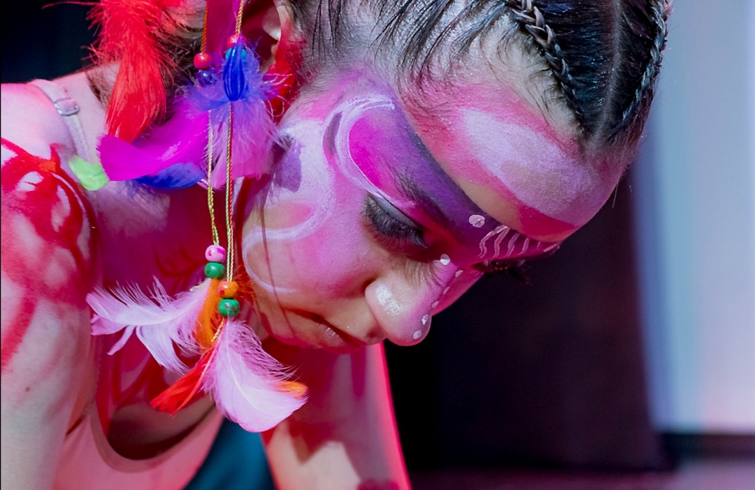 Dancer with feathered headpiece and stage makeup